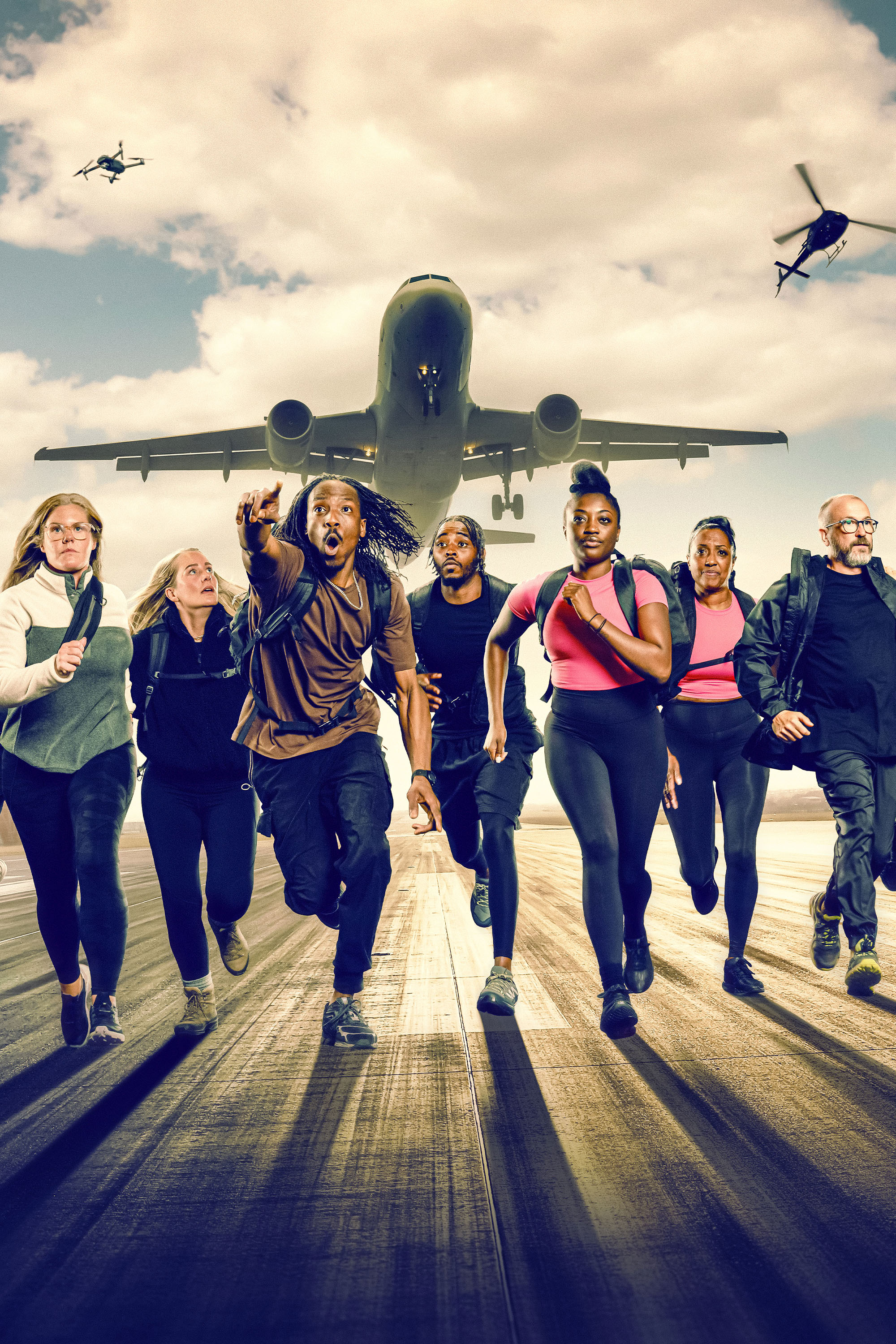 Group of young people running towards camera with plane overhead